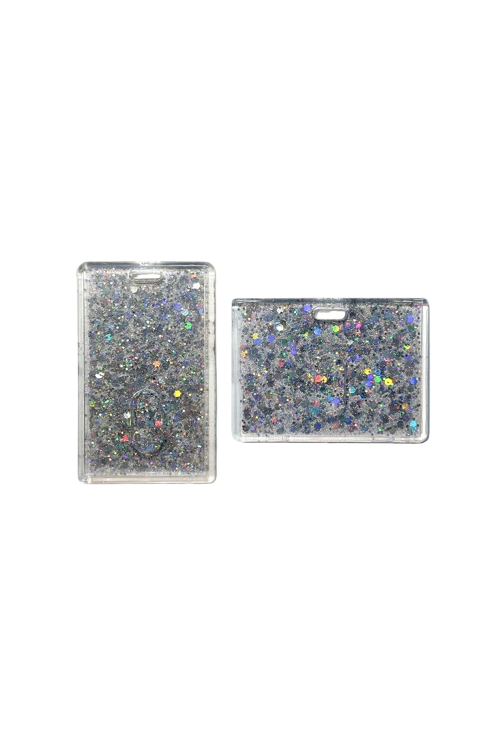 Two glittery rectangular card holders on a clear background