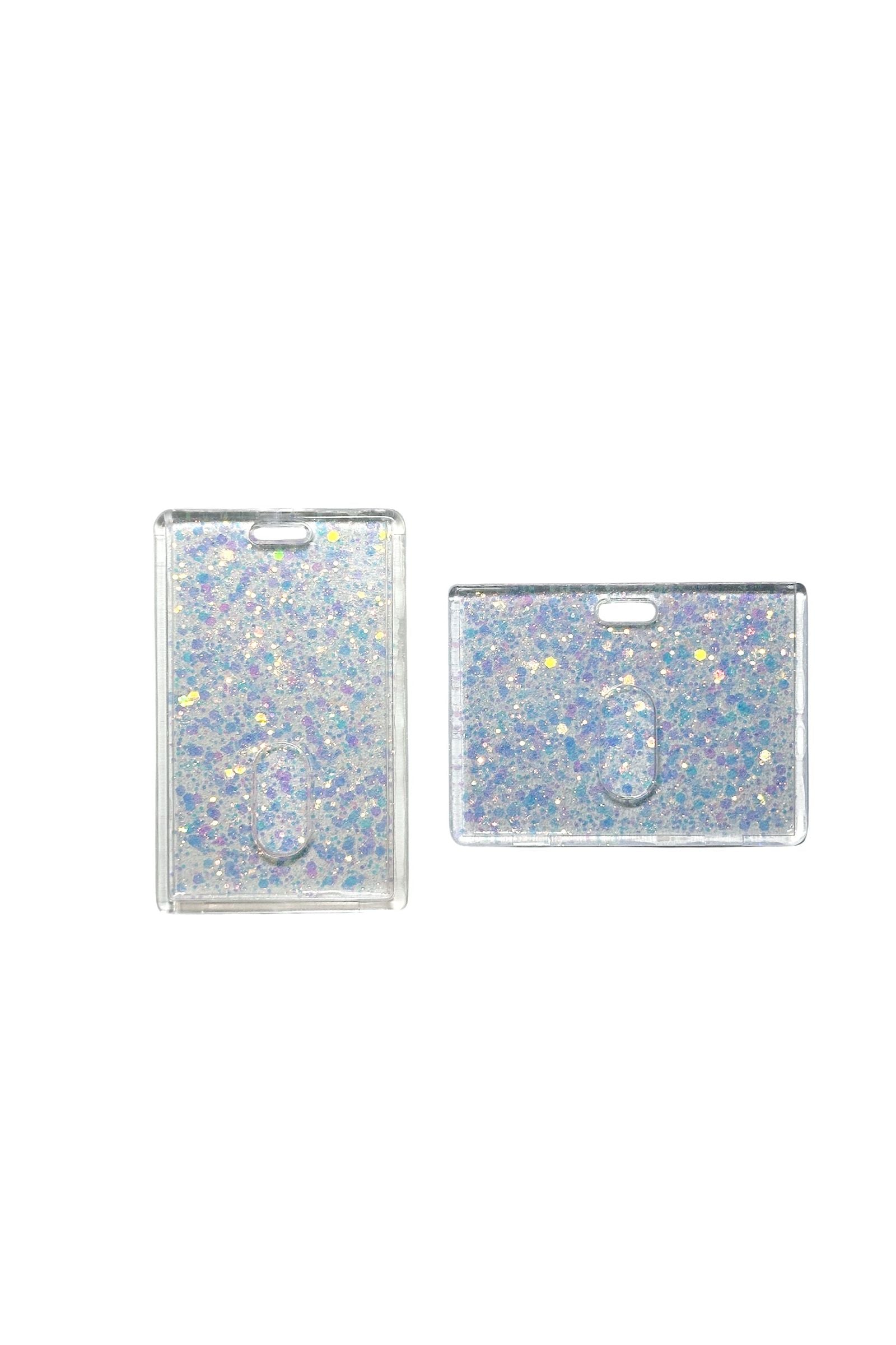 Two glittery card holders on a clear background